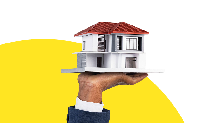 Hand holding house model